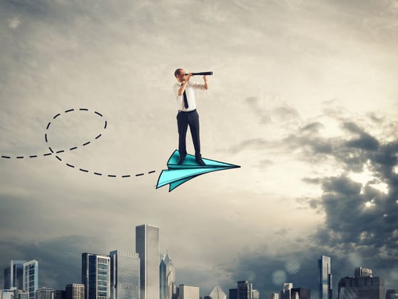 Business professional on paper airplane scanning horizon, symbolizing AI-driven marketing vision and strategy.