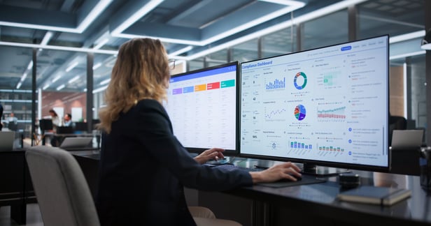 Marketer analyzing dashboards with AI insights to improve campaign performance and targeting.