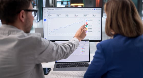 Marketing team reviewing Microsoft Ads performance data on an analytics dashboard.