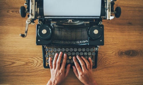 Creative process for developing unique content strategies shown with classic typewriter setup.