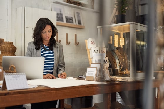 Business owner woman working behind the counter of her shop