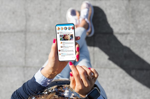 Social media feed on phone, showing how social channels fit into a guide to content marketing plans.