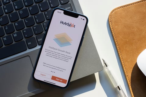 Smartphone displaying HubSpot app, a CRM tool supporting lead scoring and marketing automation for sales growth.