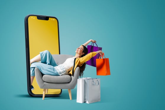 Online shopper with bags emerging from a smartphone to represent Microsoft Ads for ecommerce.