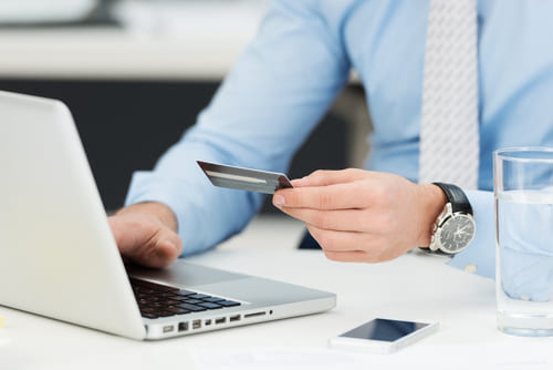 Person making online purchase as part of conversion rate optimization strategy.