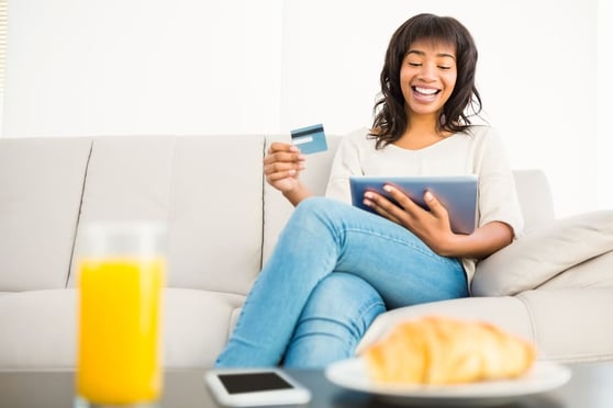 Person enjoying shopping online using a tablet as part of following the best eCommerce tips for success.