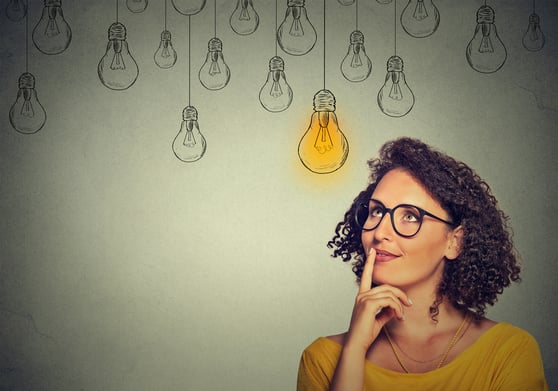 Woman with glasses thinking, representing customer segmentation strategies for personalized marketing.
