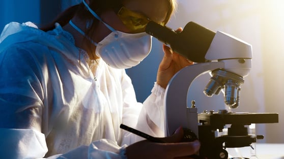 Photo Of Woman Looking Through Microscope.
