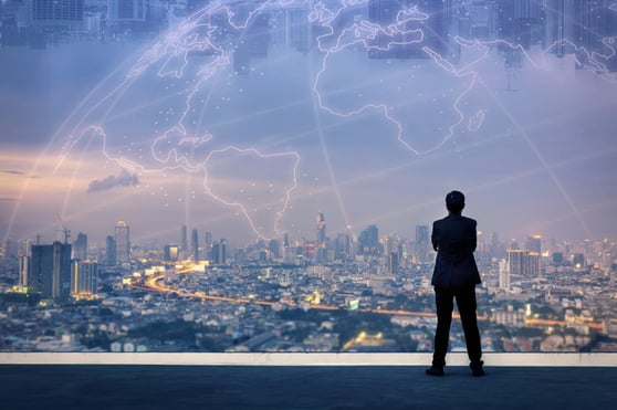Successful businessman standing with hands crossed on chest, On top of building and looking through Cityscape Skyline Night Light.