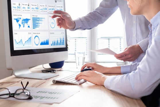 Team of business people discussing digital marketing metrics report